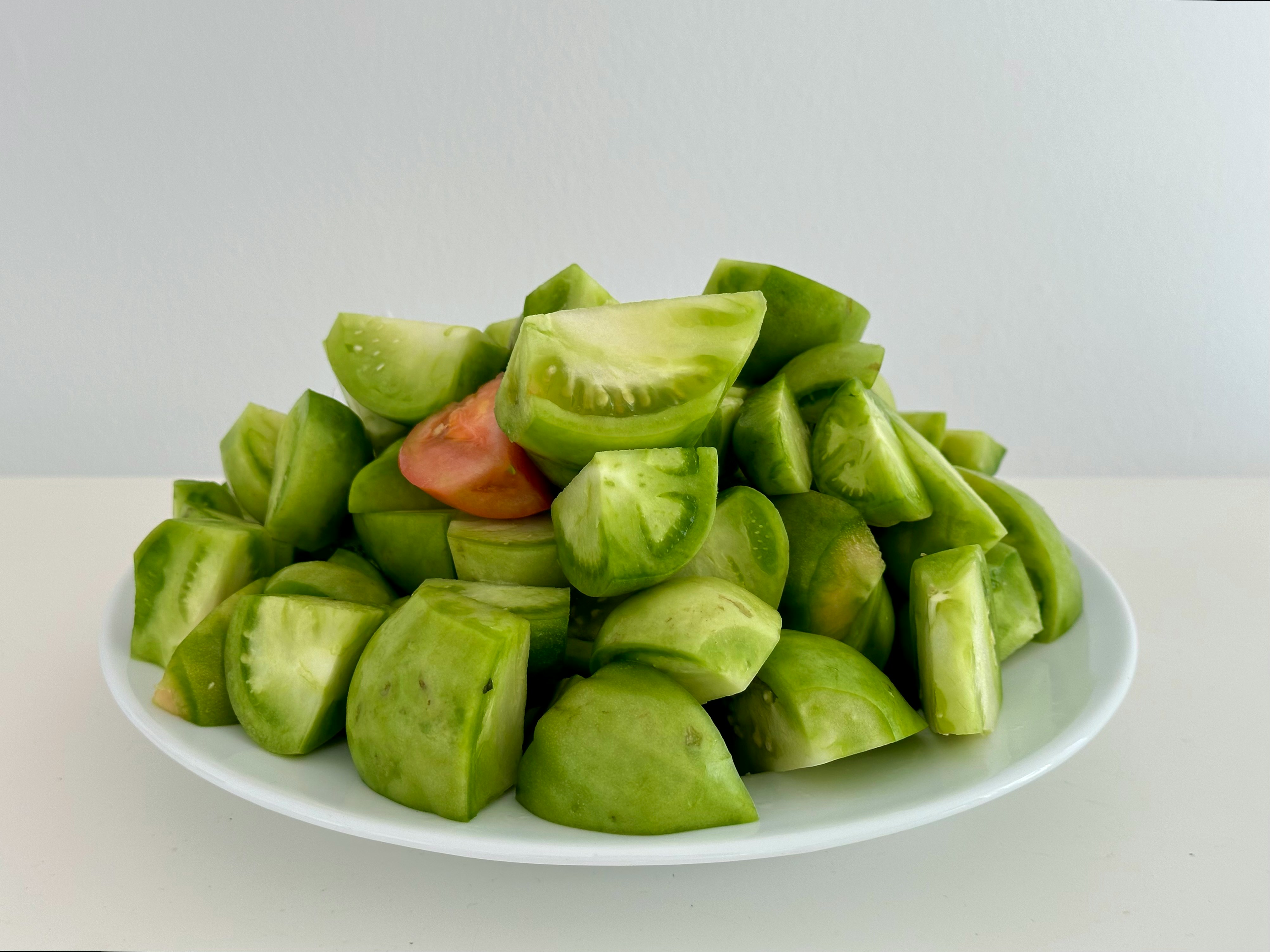 Green Zebra Tomato Plants piled on a white plate